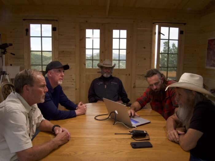 Eric Drummond, James Keenan, Duane Ollinger, Chad Ollinger and Charles Snider discuss the motives of the thief and the purpose of the cylinder he stole. (Mystery at Blind Frog Ranch (S5E4))