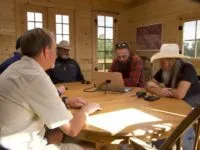 James Keenan, Eric Drummond, Duane Ollinger, Chad Ollinger and Charlie Snider review security video of a thief on the ranch.