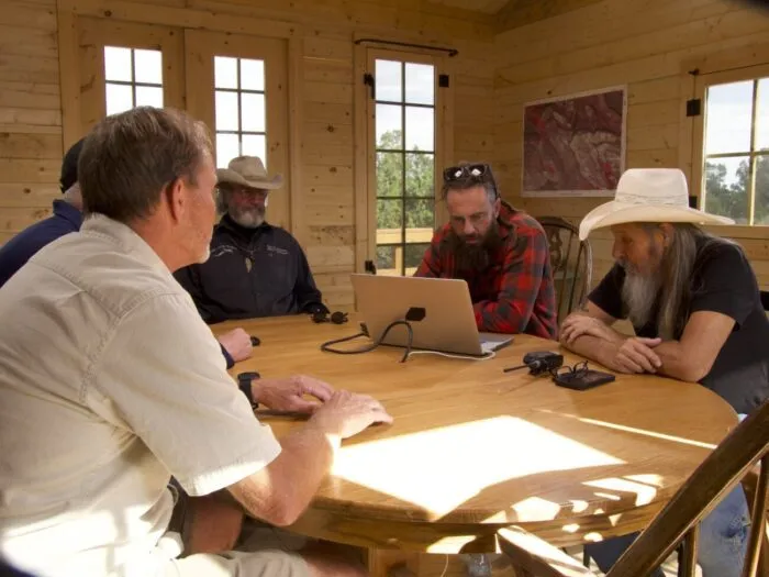 James Keenan, Eric Drummond, Duane Ollinger, Chad Ollinger and Charlie Snider review security video of a thief on the ranch.