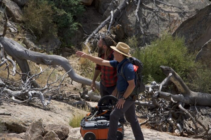 Geologist Eric Drummond points out the next target to Chad Ollinger as they carry a heavy GPR device across the ranch. (Blind Frog Ranch: Detonation Threat)