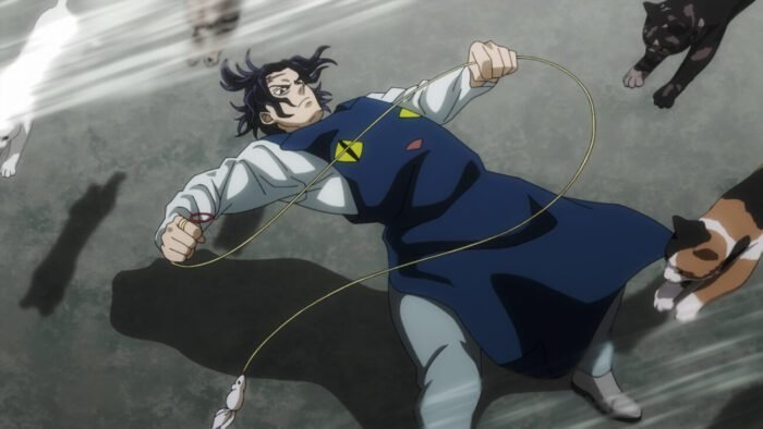 A man bends back at the knees holding a cat toy as a rush of cats fly over him.