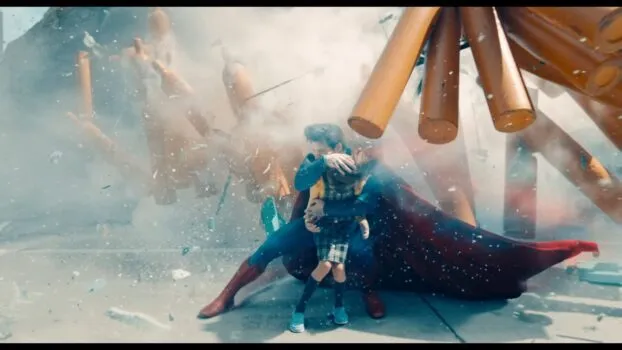 Superman guards a young girl from being hit by collapsing debris
