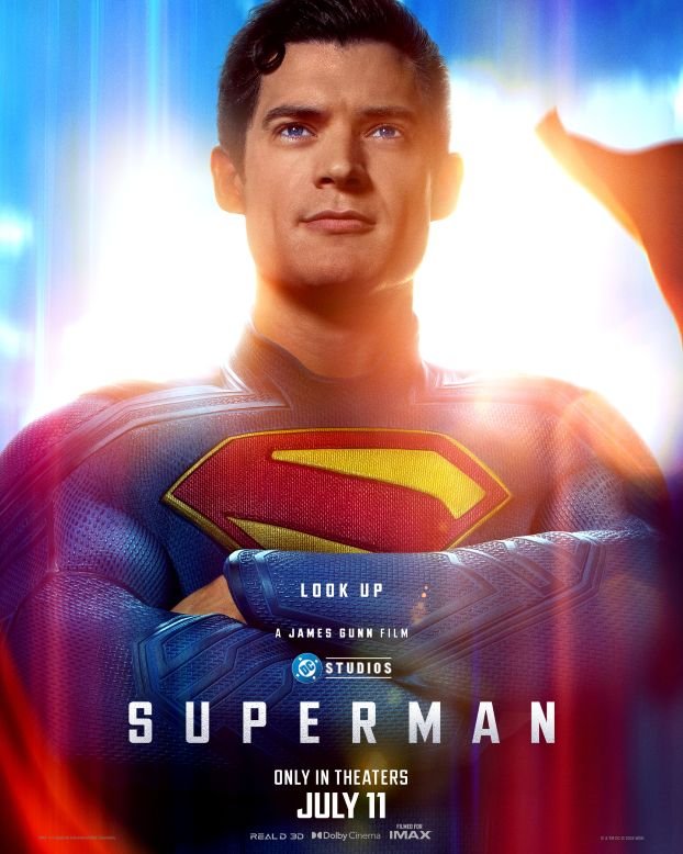 A portrait of Superman, with his arms crossed, blue and red costume on.