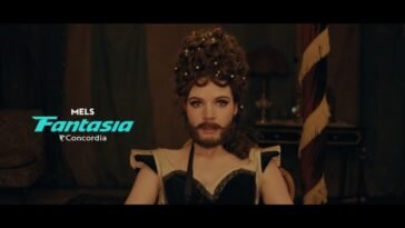 A bearded woman looks directly into the camera. (The Bearded Girl)