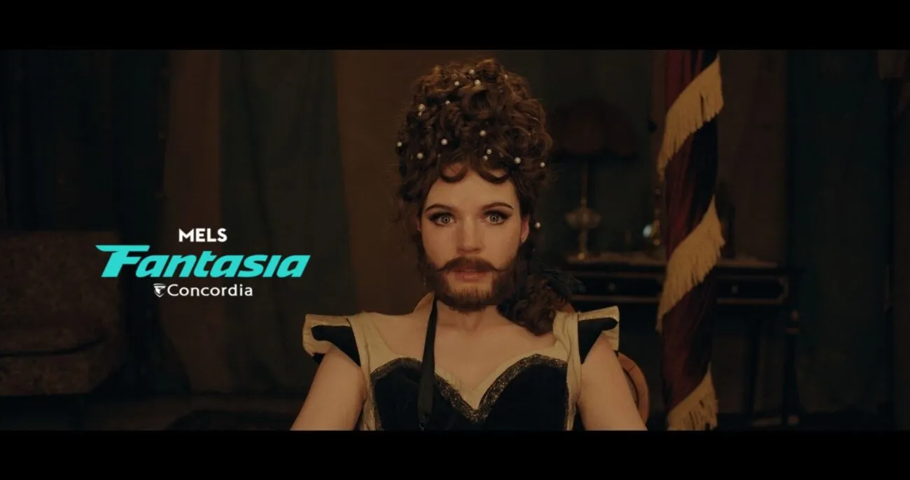 A bearded woman looks directly into the camera. (The Bearded Girl)