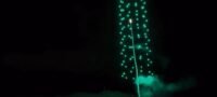 A rocket flies through the center of the drone swarm