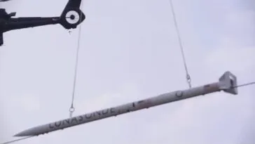 The DART is being lifted into the sky by Helicopter 1