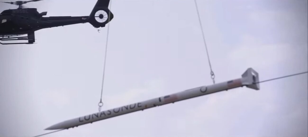 The DART is being lifted into the sky by Helicopter 1