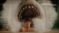 A woman texting on the phone in a bathtub has no idea a shark has emerged behind her (Hot Spring Shark Attack)