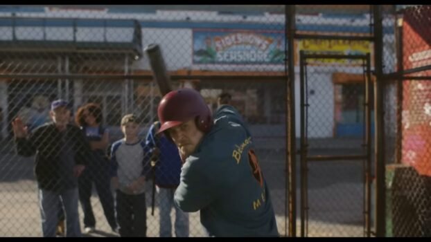 Hank (Austin Butler) is getting ready to swing in a batting cage