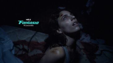 A woman lit by moonlight on a bloody bed (Hellcat)