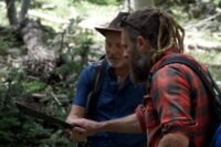 Chad Ollinger and Eric Drummond inspect Eric's machete during their hike out to the Open Pit Mine.