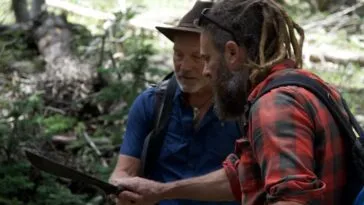 Chad Ollinger and Eric Drummond inspect Eric's machete during their hike out to the Open Pit Mine.