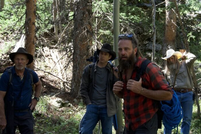 Eric Drummond, Josh Feldman, Chad Ollinger and Charlie Snider hike out to the Open Pit Mine with their metal detection and climbing gear.