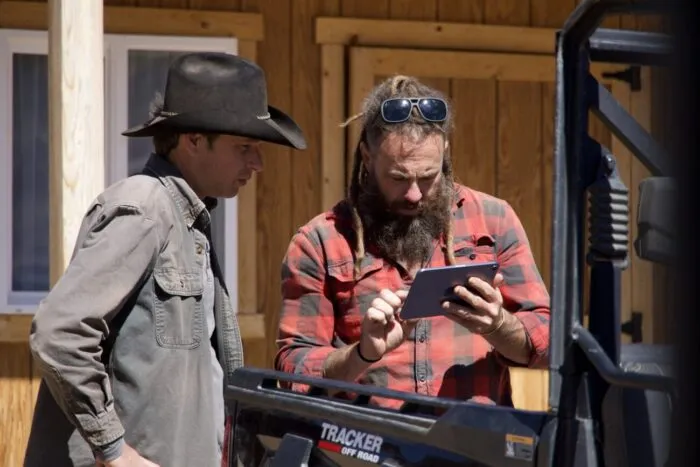 Outside of the Miner's Shack, Chad Ollinger loads surveillance footage of the intruder to show Josh Feldman.