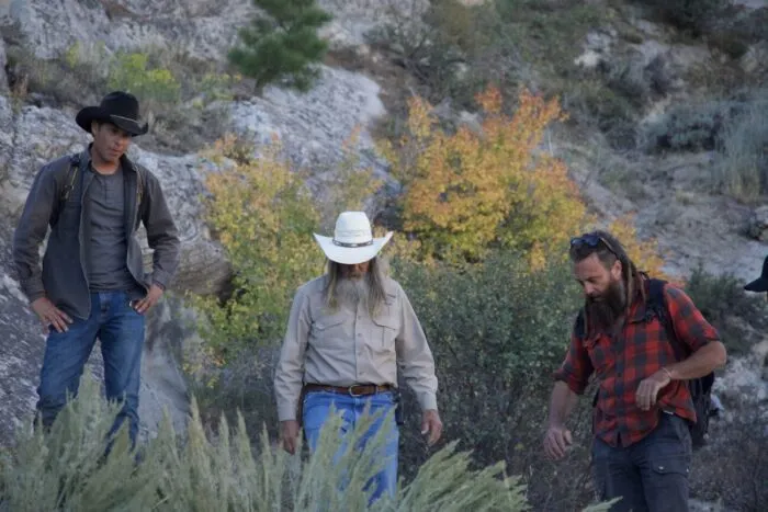Josh Feldman, Charlie Snider, and Chad Ollinger peer down into a mine and discuss the best way to explore it. (Blind Frog Ranch: The Endless Shaft)