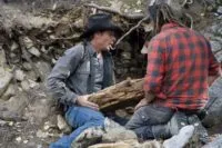 Josh Feldman and Chad Ollinger inspect an old piece of timber they suspect is hundreds of years old.