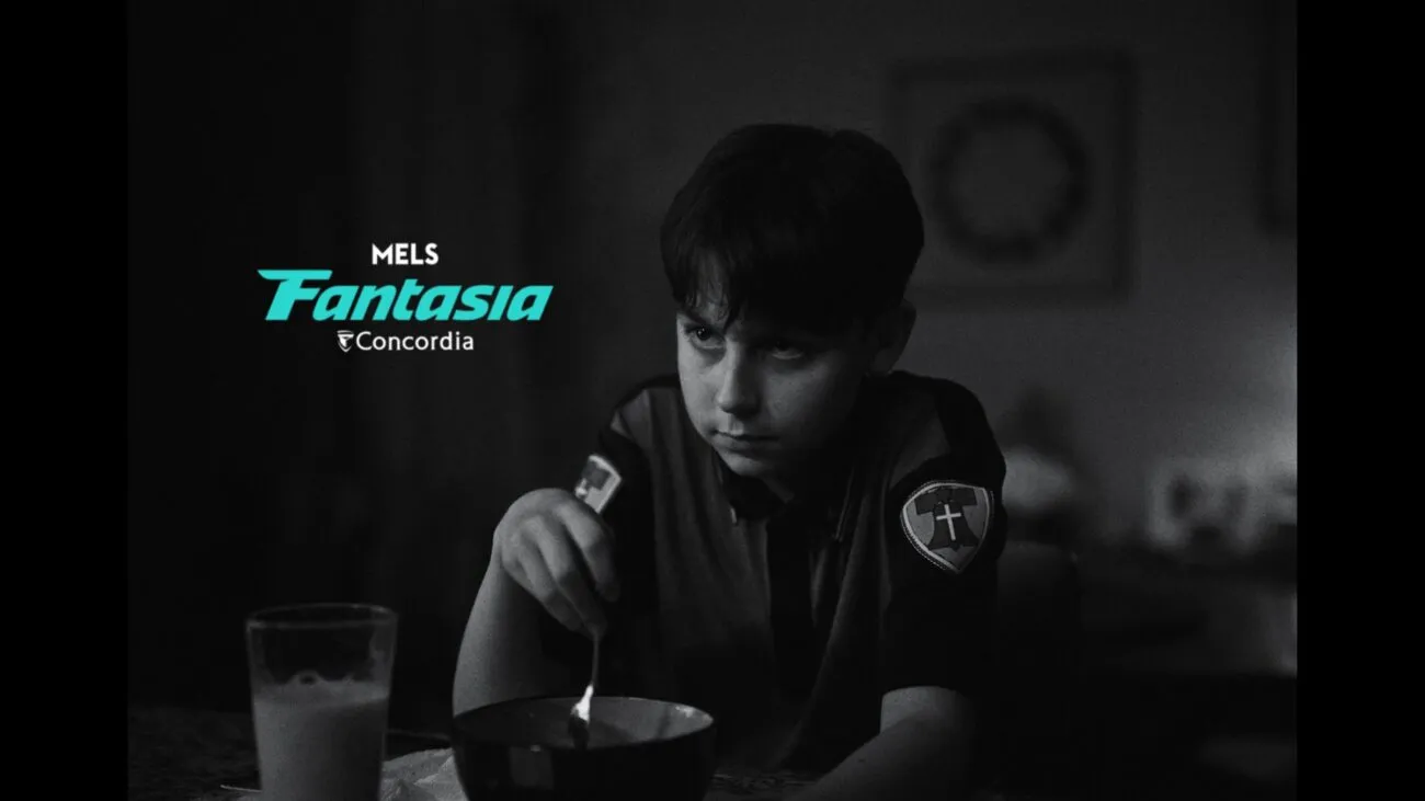 A young boy with a grimmace eats from a bowl (The School Duel)