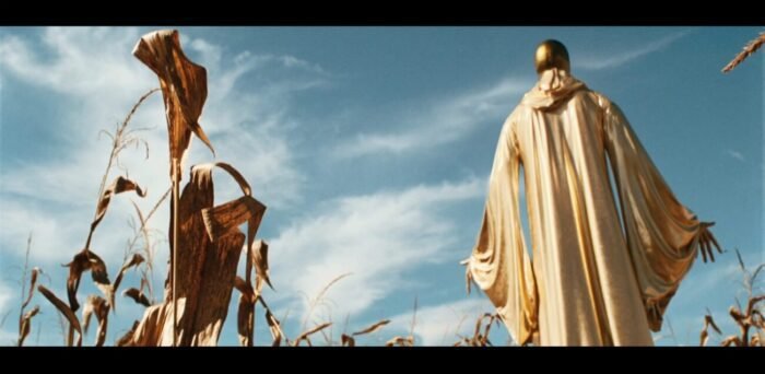 A tall gilded creature residing in the corn rows.