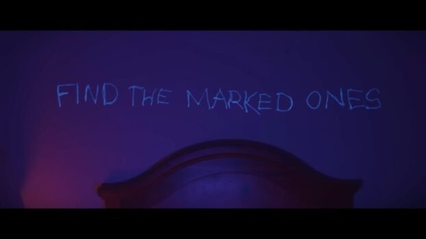 Writing on the wall is in bluelight. "Find the Marked Ones," it says.