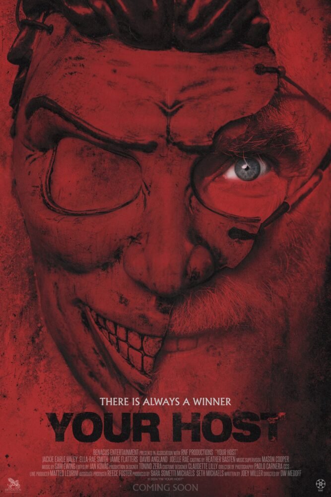 The poster for Your Host shows a broken cowl and the blue left eye and smile of the man underneath.