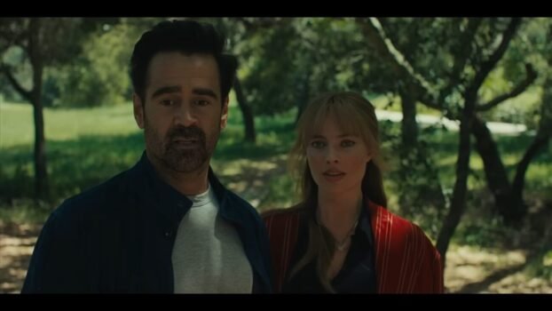 David (Colin Farrell) and Sarah (Margot Robbie) looking forward while in the woods.