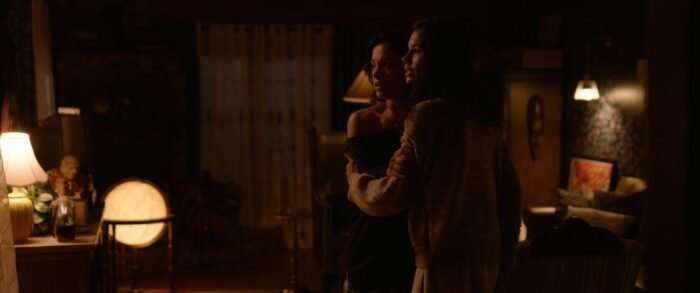 Allina and Deetz look scared as they embrace one another.