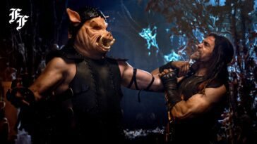 A man with the face of a pig holds a man against a wall by his throat.
