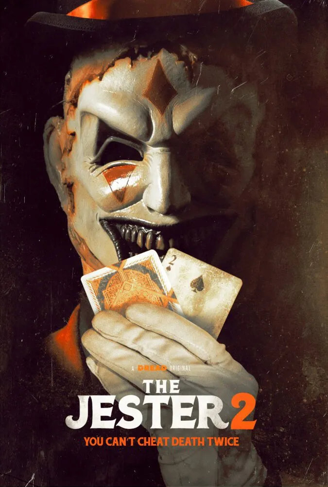 A masked man holds two cards in his white gloved hand on the poster for The Jester 2.