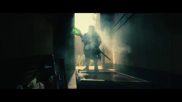 Toxie/Winston (Peter Dinklage) stands in the doorway wielding his toxic mop.