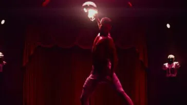 Cam (Tyriq Withers) pulls back a punch. He's in a room in all red