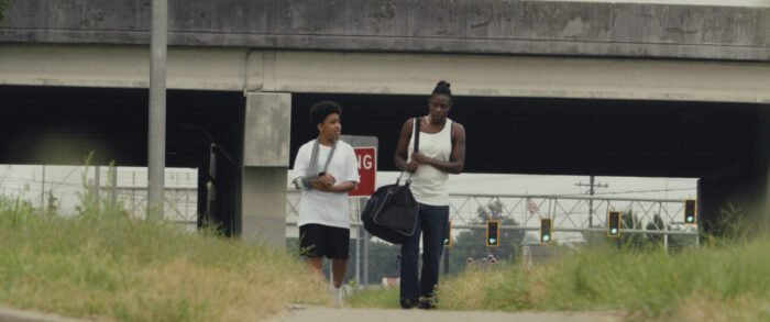 Adama Abramson as the bounty hunter, and Cohen Cooper as Alex in Landlord