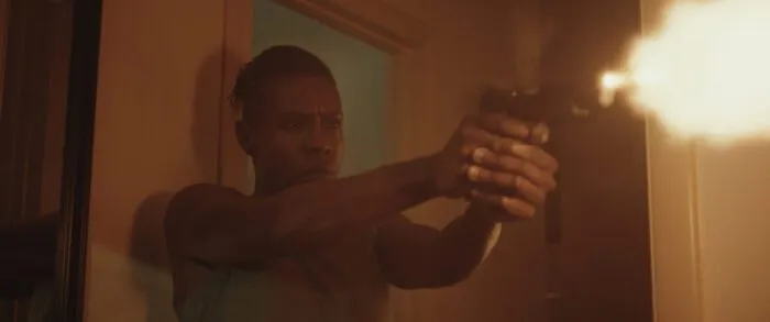 Adama Abramson as the Bounty Hunter, firing a gun in Landlord