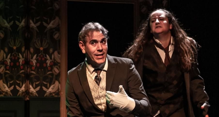 Jekyll sits while Hyde looms ominously over his left shoulder