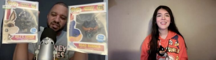 Steven Ray Byrd, wearing a Looney Tunes T-shirt, holds up Wile E. Coyote and Road Runner Funko Pops in autographed boxes while talking to Jamie Lee, wearing an orange Looney Tunes hoodie featuring Wile E. Coyote and Road Runner, a Daffy Duck key chain tied to one string on the hoodie.