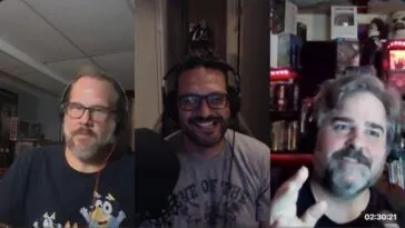 three men talking and laughing with one another