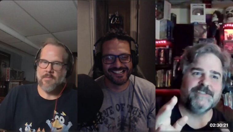 three men talking and laughing with one another