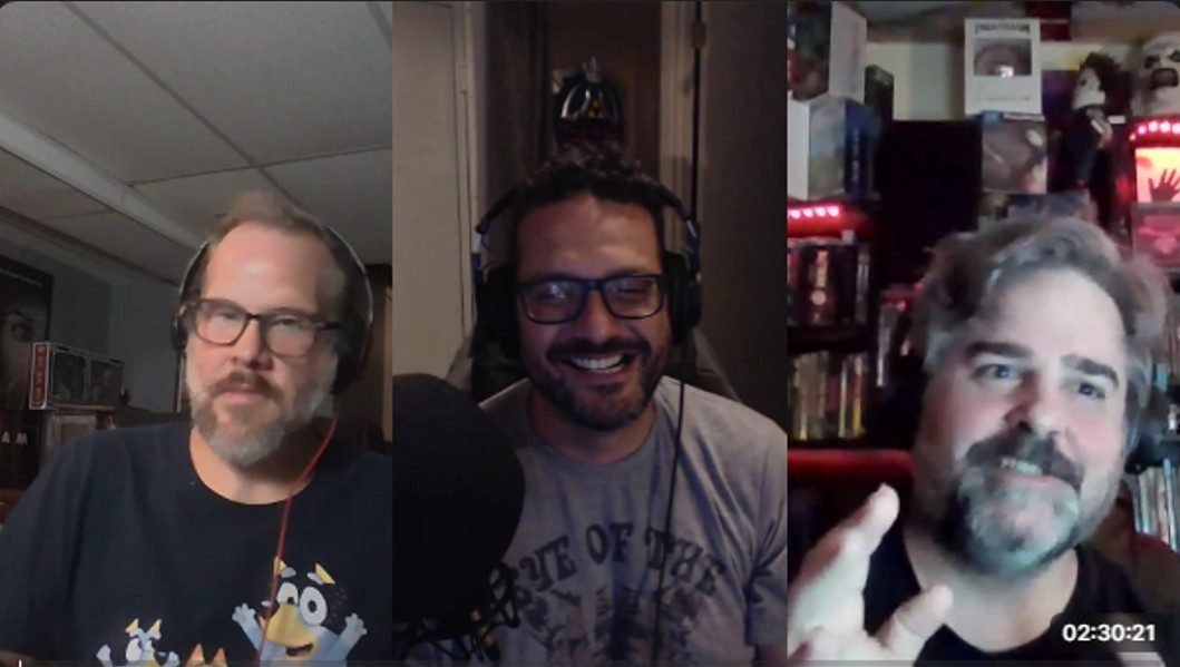 three men talking and laughing with one another