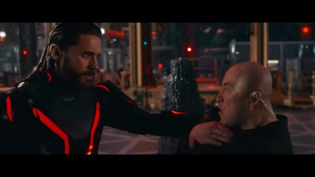 Ares has his arm on someone else's shoulder.