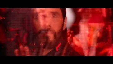 Ares (Jared Leto) looks holographic computer images in the air.