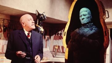 A man looks at a mummy in The Curse of the Mummy’s Tomb