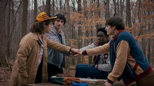 The four main characters talking about their plan in Stranger Things S5E1
