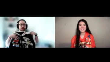 Alexis Bonhomme holds up a black and white bomber jacket featuring the Road Runner and Wile E. Coyote while talking to Jamie Lee, wearing an orange Looney Tunes hoodie featuring Wile E. Coyote and Road Runner, a Daffy Duck key chain tied to one string on the hoodie.