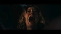 Mia (Camille Sullivan) screaming. Her face is tilted upward, and the camera is zoomed in.