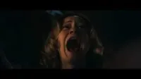Mia (Camille Sullivan) screaming. Her face is tilted upward, and the camera is zoomed in.