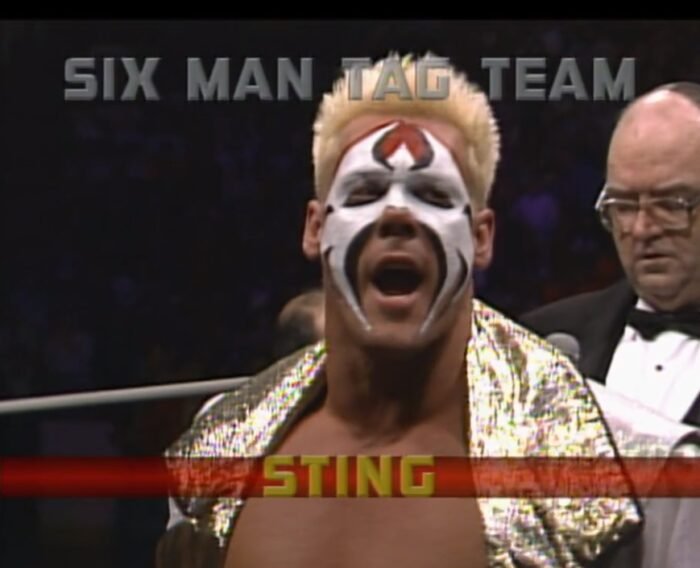 Sting howls at the crowd as a caption on-screen says "Six Man Tag Team: Sting"