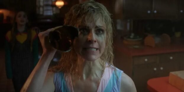 Karen Wheeler (Cara Buono) wields a broken wine bottle. She looks ahead with an angry look on her face.