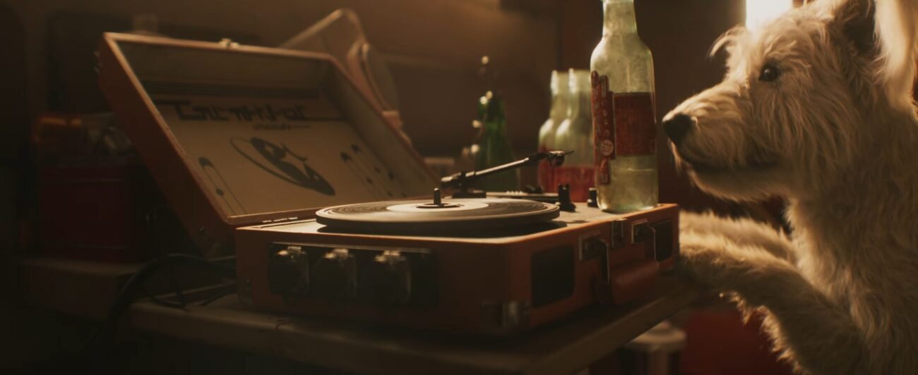 The opening shot of the Supergirl trailer, with Krypto looking at an almost empty bottle stood on a record player.