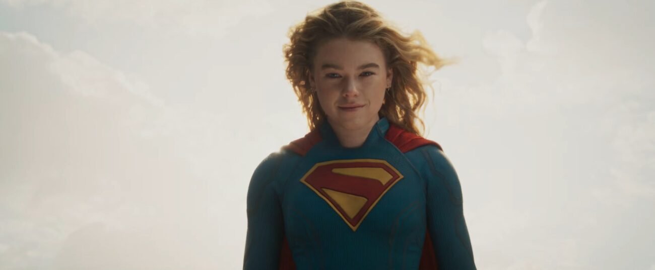 Milly Alcock as Supergirl floating in the sky, with a partial smile.