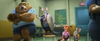 Nick and Judy sit in chairs next to armadillo who is picking a bear's hair. They are in buddy counseling.
